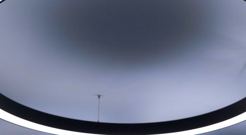 White, circular lighting on the ceiling of ICG's office in central London