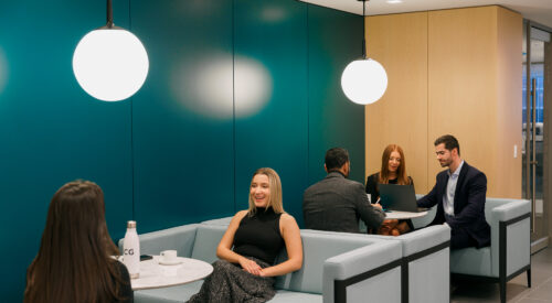 ICG employees in conversation in our Club Room in New York